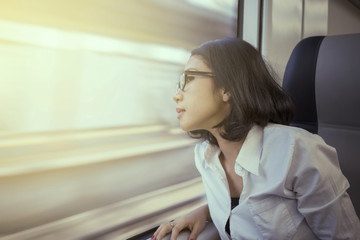 Pretty entrepreneur looking out a train window