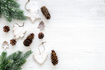 Christmas background. Spruce branch, cones and toys for decoration on white background top view copy space