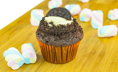 Wafer cupcake with marshmallow over wood