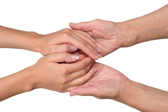 Young Woman's Hands Touching and Holding an Old Woman's Hands