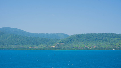 a karimun jawa big island with mountain view from ship with blue sea and sky