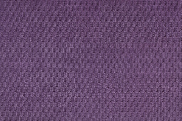 Dark violet background from soft fleecy fabric closeup. Texture of textile macro