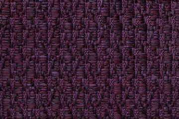 Dark purple knitted woolen background with a pattern of soft, fleecy cloth. Texture of textile closeup.