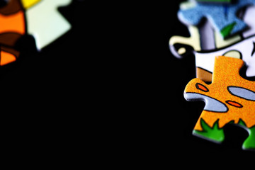 Children's puzzles scattered on a dark background close up