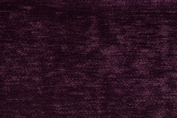 Dark purple fluffy background of soft, fleecy cloth. Texture of light nappy textile, closeup.