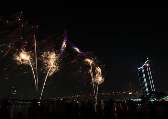 Beautiful fireworks on the banks of the Chao Phraya River at night in Bangkok, Thailand.