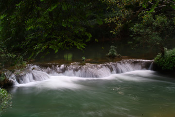 Fototapeta na wymiar Waterfalls in the lush and beautiful forests of Thailand.