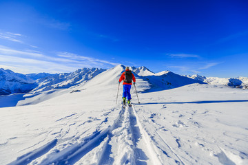Ski with amazing view of swiss famous mountains in beautiful winter snow Mt Fort. The skituring, backcountry skiing in fresh powder snow.