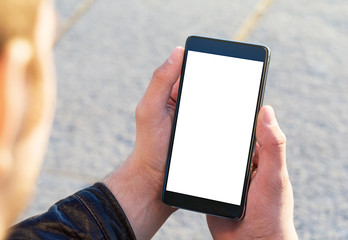 Man using his Mobile Phone outdoor, close up