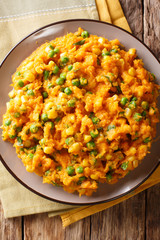 African cuisine - Irio puree of sweet potato with green peas and corn close-up on a plate. Vertical top view