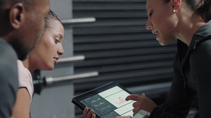 fitness woman trainer using tablet computer sharing performance results to athletes enjoying workout motivation in gym meeting healthy bodybuilding lifestyle