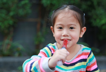 Close-up kid girl feeding with liquid medicine.
