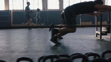 fitness athletes training bodybuilding workout strong men exercise together using weights enjoying strength challenge in gym friends practice healthy lifestyle slow motion