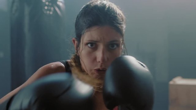portrait attractive kickboxing woman training punching exercise workout tough female fighter enjoying boxing practice in fitness gym close up