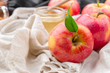 Jewish holiday Rosh Hashanah background with honey and apples on wooden table.