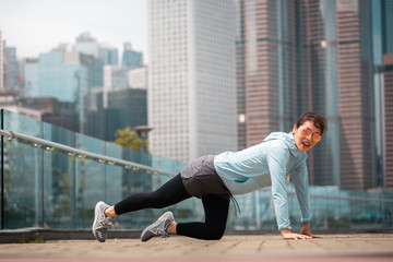 Fototapeta na wymiar Urban woman doing workout in the city