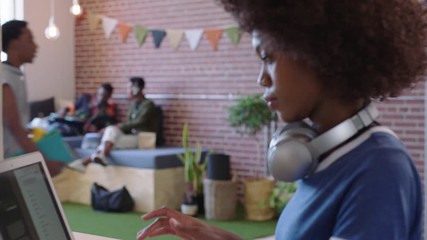 young african american business woman checking smartwatch working on creative project in trendy office workplace - Powered by Adobe