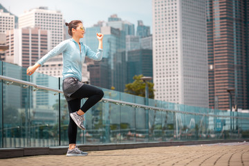 Fitness young woman workout early morning in the city 