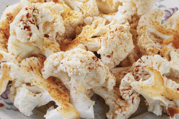 Raw cauliflower in soy sauce, prepared for baking