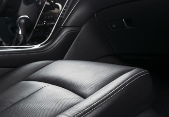 Modern Luxury car inside. Interior of prestige car. Comfortable leather seats with stitching. Black...