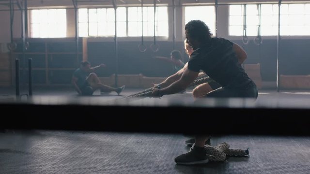 fitness athletes training intense workout strong men exercise together using weights enjoying strength challenge in gym friends bodybuilding practice healthy lifestyle slow motion