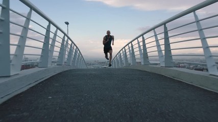 muscular young man running athlete sprinting fast intense workout challenge training endurance in urban city - Powered by Adobe