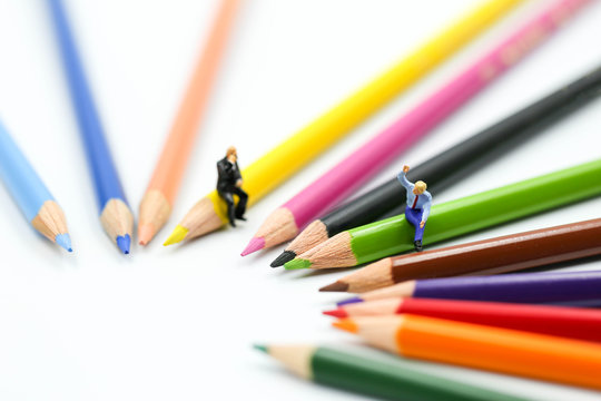 Miniature people : Businessman sitting on Color pencils,Business Education concept.