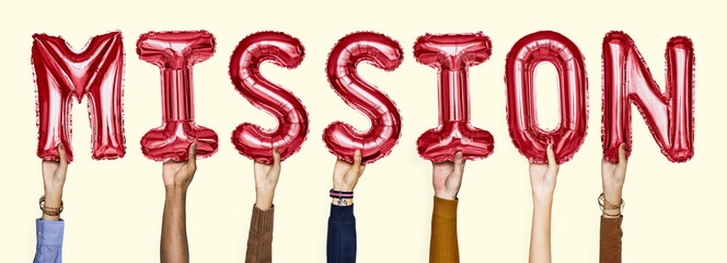 Red alphabet helium balloons forming the text mission