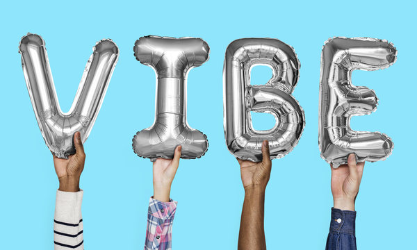 Gray silver alphabet balloons forming the word vibe