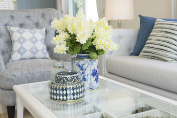 white flower in ceramic vase on table in contemporary living room