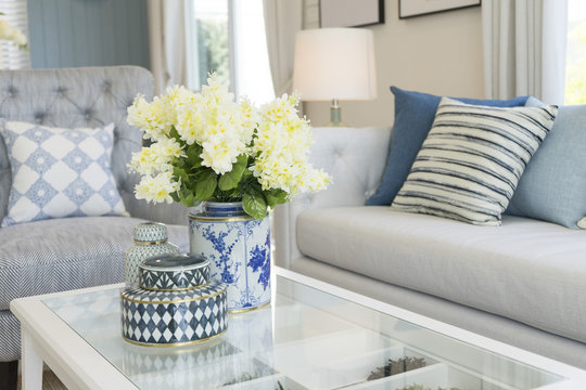white flower in ceramic vase on table in contemporary living room