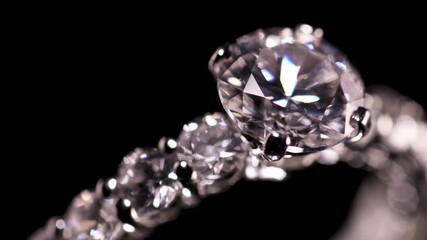 Engagement diamond ring rotating on black background, macro with shallow DoF - Powered by Adobe