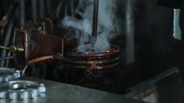 Hardening and heat treatment of metal parts for mechanical engineering, close-up, heat treatment of metal parts and products on a call, close-up, industry, production