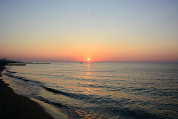 The sun rises from the sea