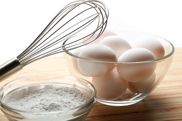 Eggs, Flour And Scutcher On Wooden Table Close-up
