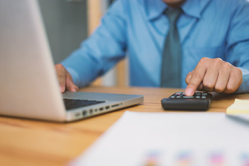 calculate,finance,accounting,Business people analyzing investment charts with calculator .Accounting technology,using laptop at office,Analyze plans document paper graph chart business marketing plan.