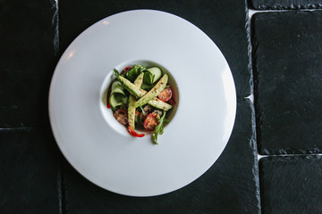 Salad with vegetables and avocado on a large plate