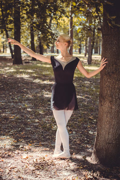 Ballet dancer dancing in the city park. Sensual ballerina in nature. Ballerina on the streets. Ballerina out of doors, young modern ballet dancer posing 