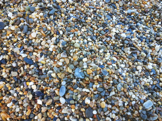 Colorful pebbles on beach texture