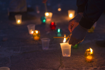 A man lights a candle. Day of Remembrance for the Bereaved