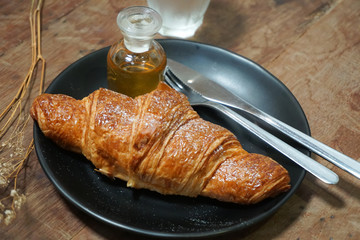 croissants with honey on plate close yummy