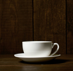 one classic coffee or tea cup on a dark wooden background