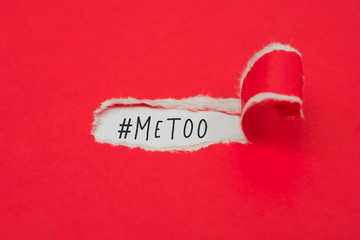 Torn red paper revealing the word #metoo concept.