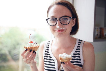 girl eating tasty cakes, sitting by the window, sweet food and pleasure
