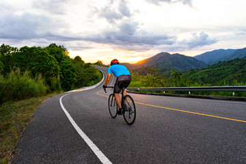 Fototapeta premium Cycling competition,cyclist athletes riding a race at high speed on road way, Sports men bikes in the morning,vintage color,selective focus, sports concept,low angle view,Business competition