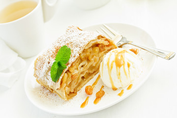 apple strudel with cinnamon and an ice cream ball.