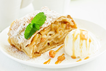 apple strudel with cinnamon and an ice cream ball.