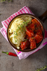 Pork goulash meat with dumplings on a rustic bowl