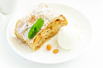 apple strudel with cinnamon and an ice cream ball.