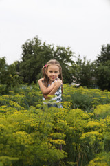 Obraz premium Little girl hugging herself in a summer garden